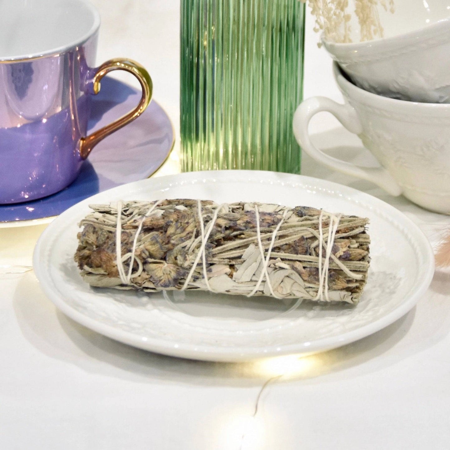 Fagot lavande apaisante sur une assiette blanche, accompagné de tasses élégantes et d'une décoration douce