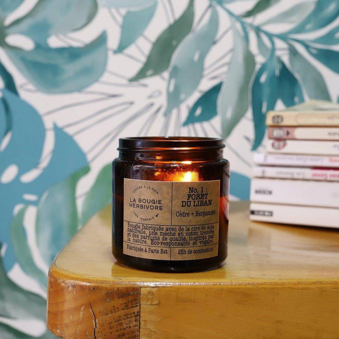 Bougie parfumée cèdre bergamote de la Bougie Herbivore sur une table en bois, illuminée et élégante.
