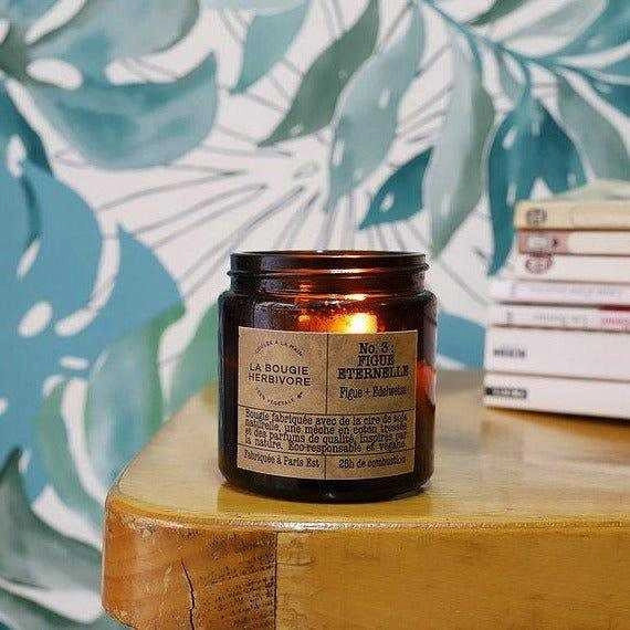 Bougie parfumée figue de La Bougie Herbivore dans un pot en verre sur un fond décoratif moderne