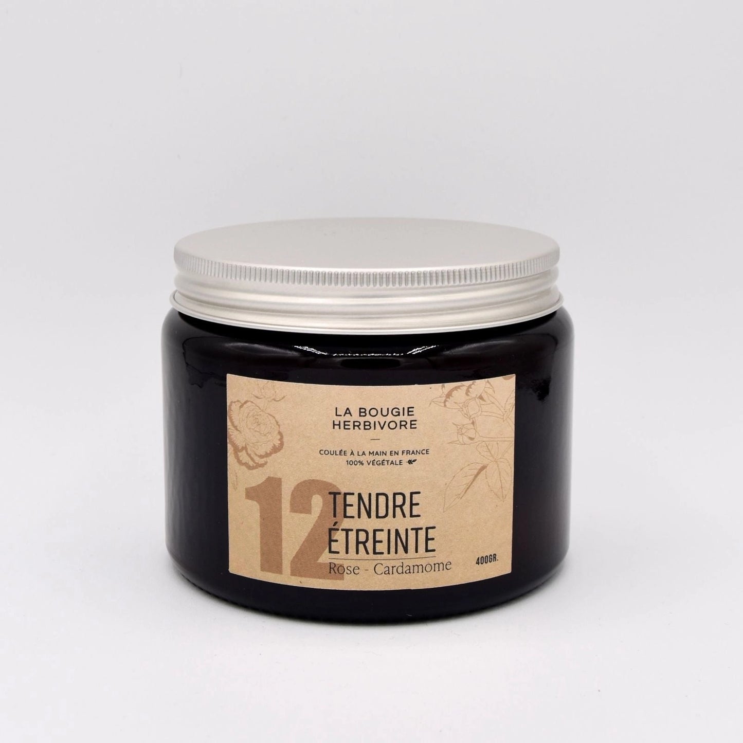 Bougie rose cardamome de La Bougie Herbivore dans un pot en verre noir avec couvercle blanc